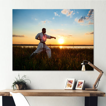 Man Training Karate In Field At Sunrise - Aerobic & Bodybuilding Canvas Wall Art